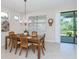 Dining room with wooden table, chairs, and access to the backyard at 11945 Lovegrass St, Venice, FL 34293