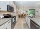 Bright kitchen features granite counters, stainless steel appliances, and breakfast nook at 11945 Lovegrass St, Venice, FL 34293