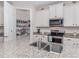 Kitchen boasts granite countertops, stainless steel appliances, and walk-in pantry at 11945 Lovegrass St, Venice, FL 34293