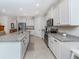 Modern kitchen with large island, stainless steel appliances, and granite countertops at 11945 Lovegrass St, Venice, FL 34293