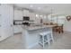 Modern kitchen with granite island, white cabinets and breakfast area at 11945 Lovegrass St, Venice, FL 34293