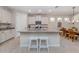 Modern kitchen with granite island, white cabinets and breakfast area at 11945 Lovegrass St, Venice, FL 34293