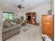 Bright living room with comfortable seating and built-in shelving at 11945 Lovegrass St, Venice, FL 34293