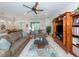 Bright and airy living room features comfortable seating, large windows, and ceiling fan at 11945 Lovegrass St, Venice, FL 34293