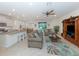 Spacious living room with neutral decor, plush sofas, and a ceiling fan at 11945 Lovegrass St, Venice, FL 34293