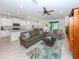 Open living room and kitchen area with tile floors and neutral colors at 11945 Lovegrass St, Venice, FL 34293