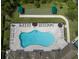 Aerial view of resort-style pool with bocce ball, lounge chairs, and umbrellas at 11945 Lovegrass St, Venice, FL 34293