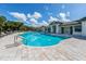 Community pool with lounge chairs and a clubhouse at 11945 Lovegrass St, Venice, FL 34293