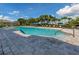 Community pool with lounge chairs and a spacious deck at 11945 Lovegrass St, Venice, FL 34293