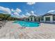 Community pool with lounge chairs and a clubhouse at 11945 Lovegrass St, Venice, FL 34293