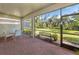 Enjoy this screened patio with seating area and serene nature views at 11945 Lovegrass St, Venice, FL 34293