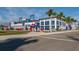 Exterior view of a modern stadium with palm trees and parking at 11945 Lovegrass St, Venice, FL 34293