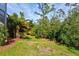 Landscaped backyard with a pathway through the natural vegetation at 12460 Davie Ct, Venice, FL 34293