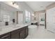 Spa-like bathroom with a freestanding tub, double vanity, and marble flooring at 12460 Davie Ct, Venice, FL 34293