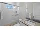 Clean bathroom with a walk-in shower and tiled walls at 12460 Davie Ct, Venice, FL 34293