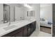 Double vanity bathroom with dark brown cabinets at 12460 Davie Ct, Venice, FL 34293