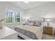 Bright bedroom with a king-size bed and neutral decor at 12460 Davie Ct, Venice, FL 34293