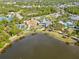 Aerial view of community amenities including pool, tennis courts, and lake at 12460 Davie Ct, Venice, FL 34293