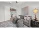 Cozy den featuring a gray sofa, two side tables, and a large piece of art at 12460 Davie Ct, Venice, FL 34293
