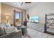 Comfortable den with a gray sofa, side tables, and a large TV at 12460 Davie Ct, Venice, FL 34293