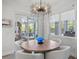 Charming dining room with a round wooden table and four white chairs at 12460 Davie Ct, Venice, FL 34293