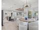 Open concept dining room with kitchen view and modern chandelier at 12460 Davie Ct, Venice, FL 34293