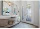 Elegant entryway with a statement console table and mirror at 12460 Davie Ct, Venice, FL 34293