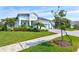 Two-story house with white siding, landscaping, and a paved driveway at 12460 Davie Ct, Venice, FL 34293