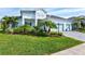 Two-story house with light-colored siding, light blue garage doors, and a paver driveway at 12460 Davie Ct, Venice, FL 34293