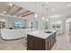Modern kitchen with a large island, stainless steel appliances, and white cabinets at 12460 Davie Ct, Venice, FL 34293