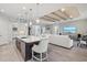 Open kitchen boasts a large island, stainless steel appliances, and dark wood cabinets at 12460 Davie Ct, Venice, FL 34293