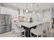Gourmet kitchen with white cabinets, quartz countertops, and stainless steel appliances at 12460 Davie Ct, Venice, FL 34293