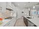 Modern kitchen with white cabinets, stainless steel appliances, and a large island at 12460 Davie Ct, Venice, FL 34293
