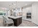 Modern kitchen with white cabinets, quartz countertops, and stainless steel appliances at 12460 Davie Ct, Venice, FL 34293