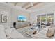 Spacious living room with hardwood floors, comfortable seating, and a large TV at 12460 Davie Ct, Venice, FL 34293