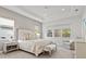 Spacious main bedroom with a large bed, seating area, and plenty of natural light at 12460 Davie Ct, Venice, FL 34293