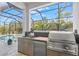 Stainless steel appliances highlight this outdoor kitchen at 12460 Davie Ct, Venice, FL 34293