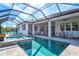 Relaxing pool and spa area with covered patio and outdoor seating at 12460 Davie Ct, Venice, FL 34293