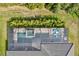 Aerial view of a screened pool and spa with surrounding patio at 12460 Davie Ct, Venice, FL 34293