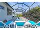 Relaxing pool and patio area with lounge chairs and screened enclosure at 12460 Davie Ct, Venice, FL 34293