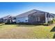 House with backyard, screened patio, and lake view at 12488 Palatka Dr, Venice, FL 34293