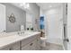 Bathroom with single vanity, shower, and beach-themed decor at 12488 Palatka Dr, Venice, FL 34293