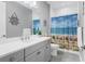 Bathroom with single vanity, shower/tub combo, and beach-themed decor at 12488 Palatka Dr, Venice, FL 34293