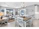 Bright dining room with white table and chairs and access to backyard at 12488 Palatka Dr, Venice, FL 34293