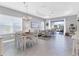 Open concept dining room with white table and chairs, view of living room and patio at 12488 Palatka Dr, Venice, FL 34293