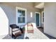 Relaxing patio furniture on a covered porch at 12488 Palatka Dr, Venice, FL 34293