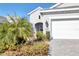 House exterior with landscaping and two car garage at 12488 Palatka Dr, Venice, FL 34293