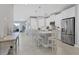 Spacious kitchen with island, stainless steel appliances, and white cabinets at 12488 Palatka Dr, Venice, FL 34293