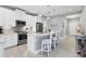 Modern kitchen with white cabinets, stainless steel appliances, and an island at 12488 Palatka Dr, Venice, FL 34293