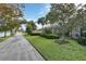 Landscaped backyard with walkway leading to a bridge and waterway at 13240 Guyana St, Venice, FL 34293